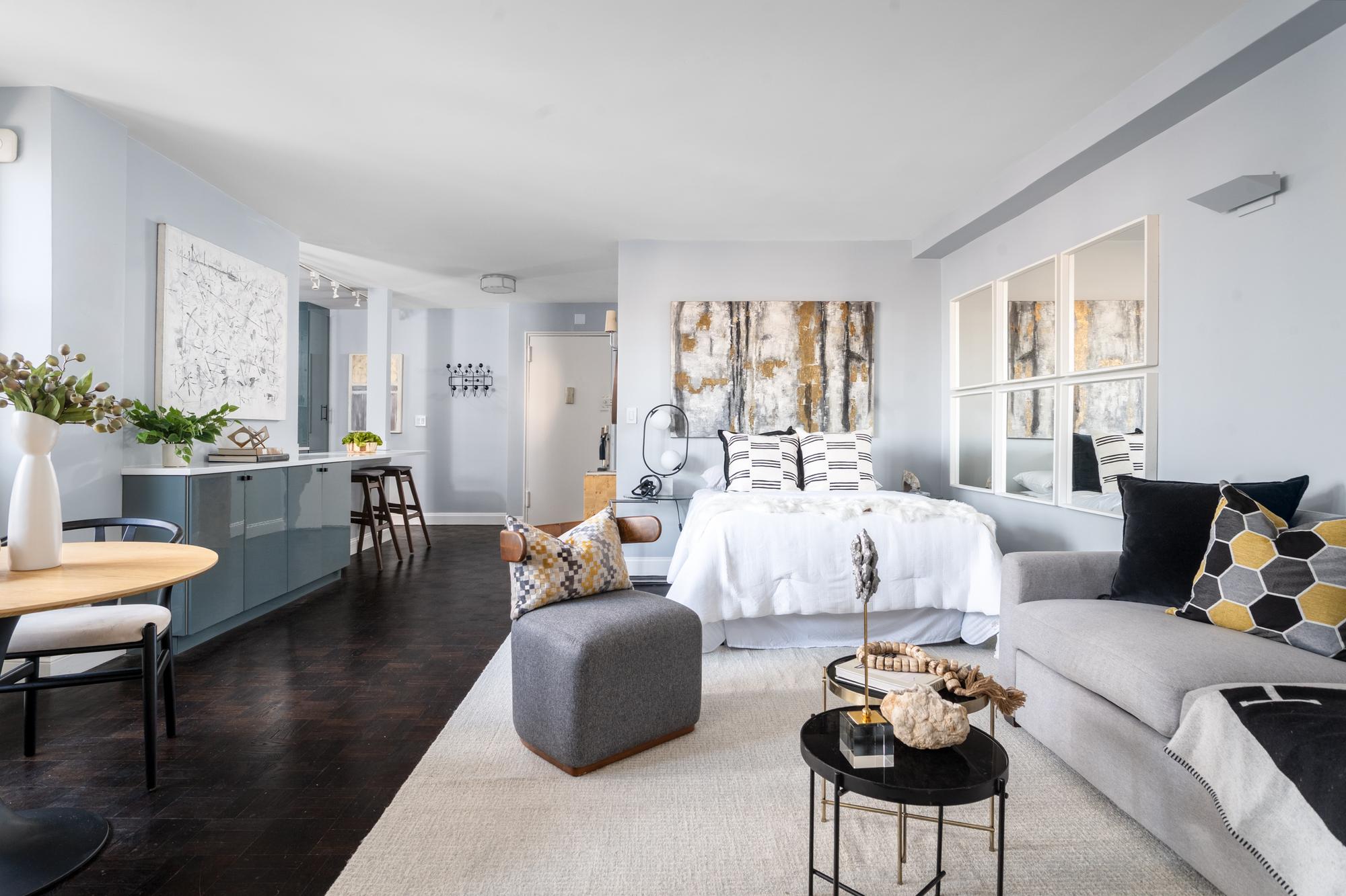 315 East 72nd Street, Unit 16A Manhattan, NY 10021 - Photo 1 of 12 a living room with furniture and a large window