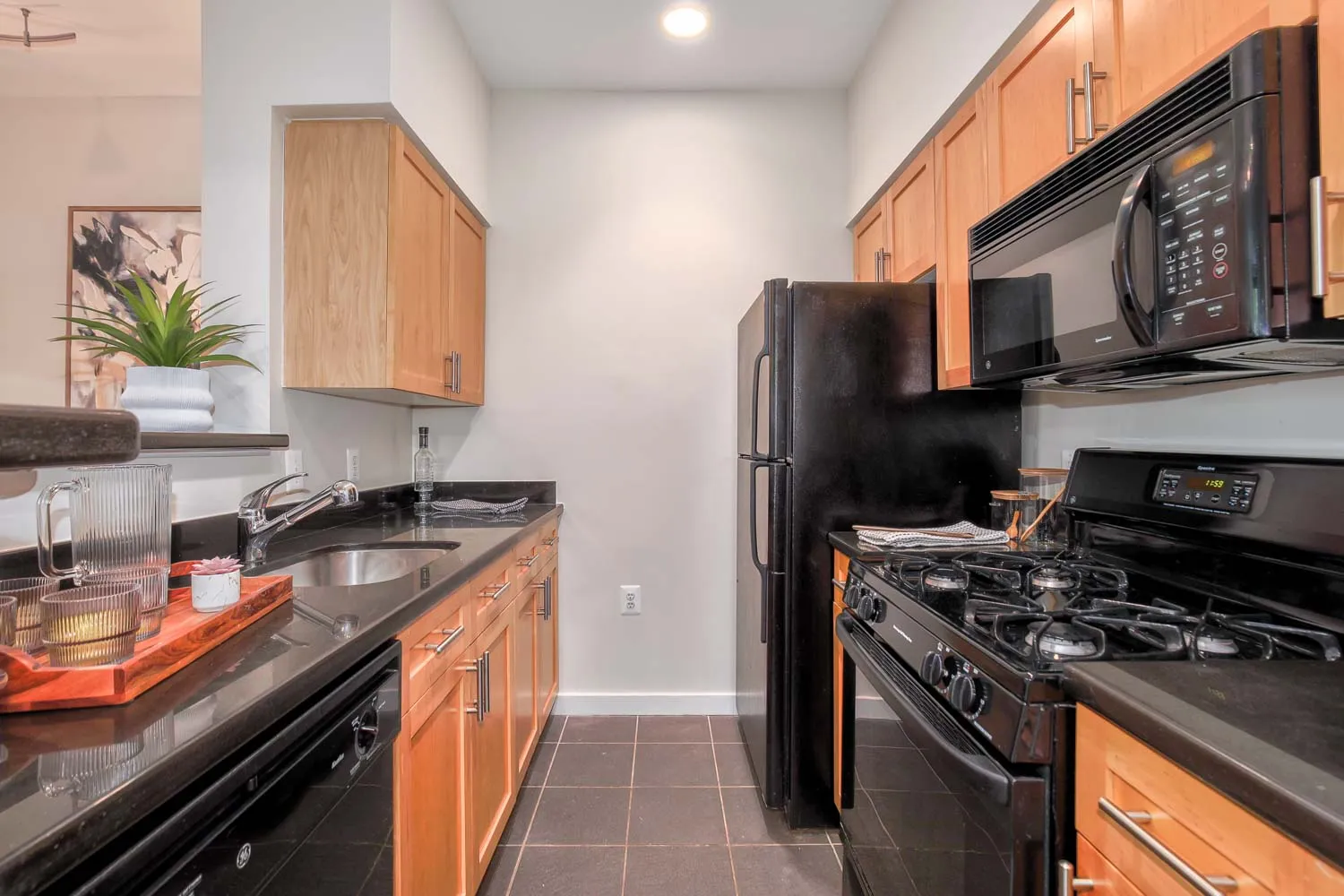 a kitchen with stainless steel appliances granite countertop a stove refrigerator and a sink