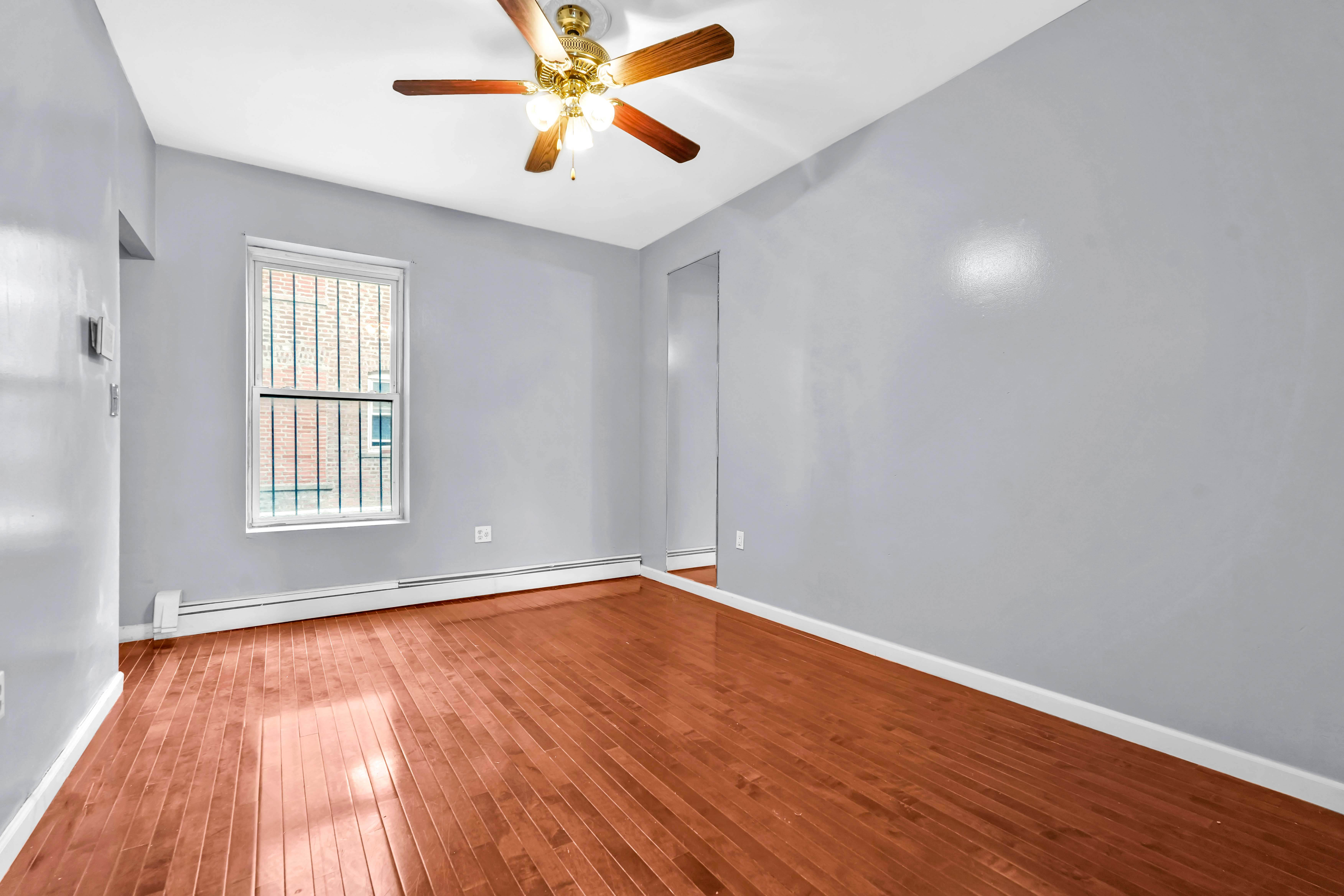 1633 St Johns Place, Unit 3 Brooklyn, NY 11233 - Photo 5 of 29 wooden floor in an empty room with a window
