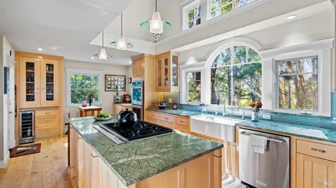 a kitchen with stainless steel appliances granite countertop a stove and a sink