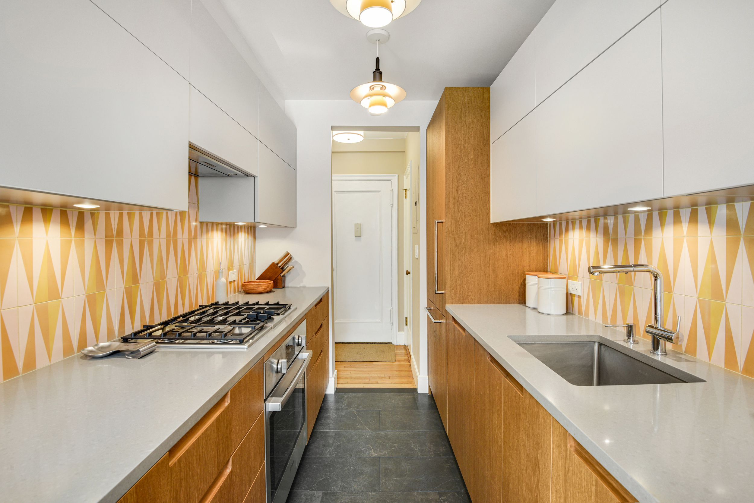 205 East 78th Street, Unit 7K Manhattan, NY 10075 - Photo 7 of 14 a kitchen with stainless steel appliances a sink a stove and a refrigerator