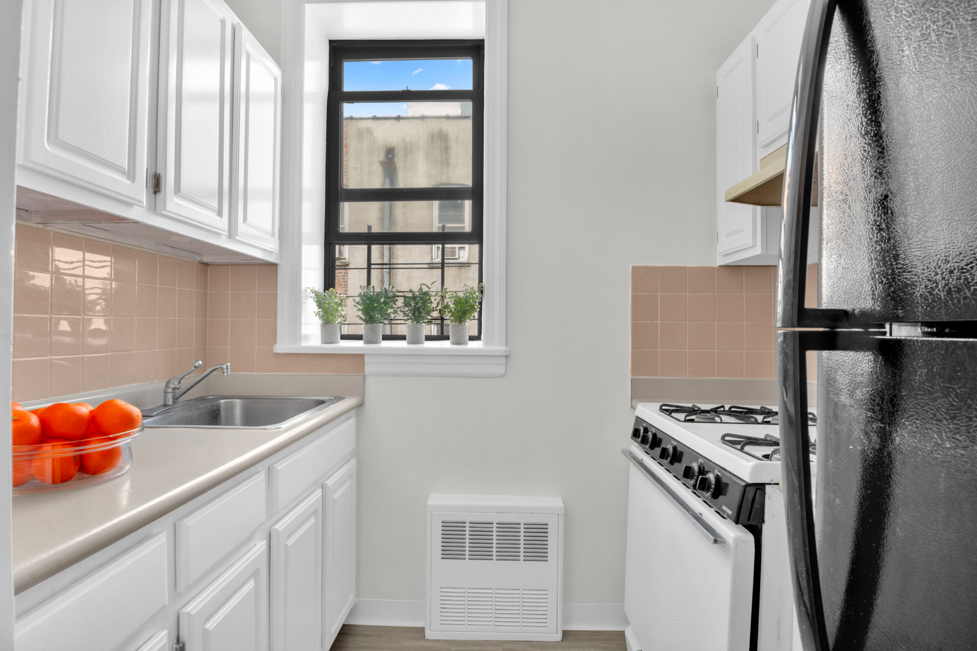469 West 166th Street, Unit 4C Manhattan, NY 10032 - Photo 10 of 12 a kitchen with stainless steel appliances granite countertop a sink stove and refrigerator