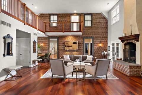 a living room with fireplace furniture and a wooden floor