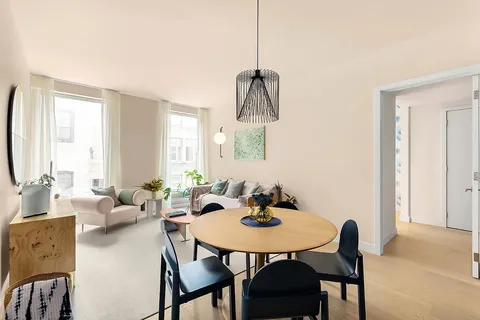 a view of a dining room with furniture and window