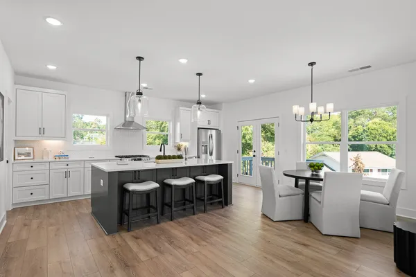 a kitchen with counter space appliances and wooden floor