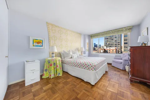 a spacious bedroom with a bed and a large window