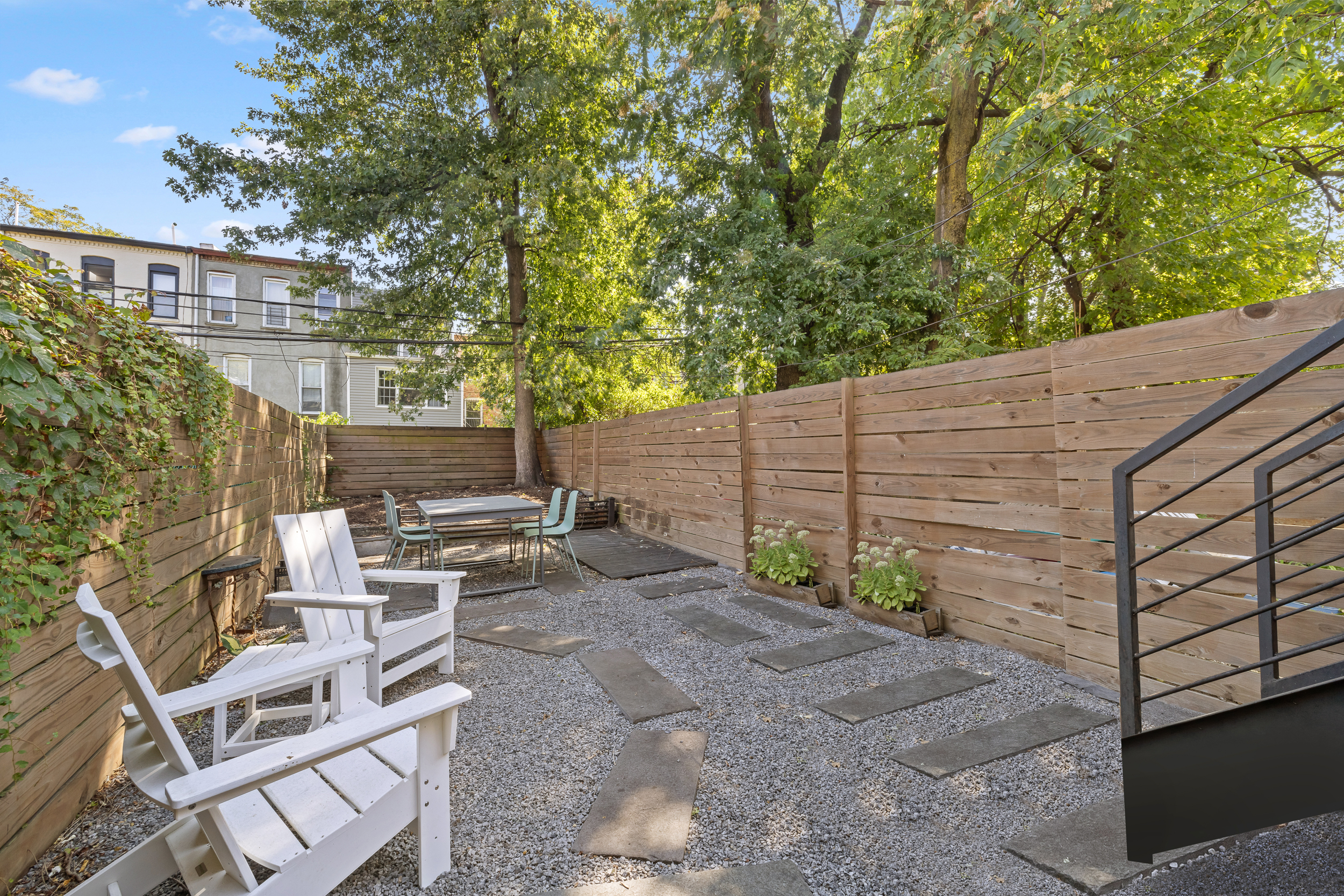 716 Monroe Street Brooklyn, NY 11221 - Photo 16 of 22 a backyard of a house with large tree and wooden fence