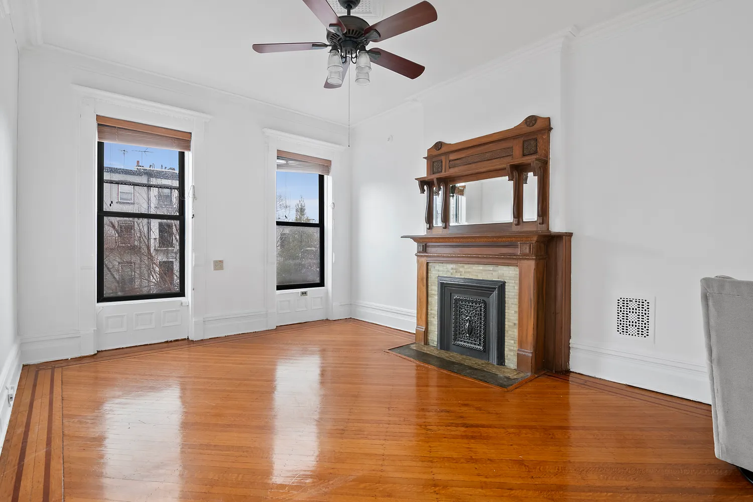 a view of empty room with wooden floor and fireplace