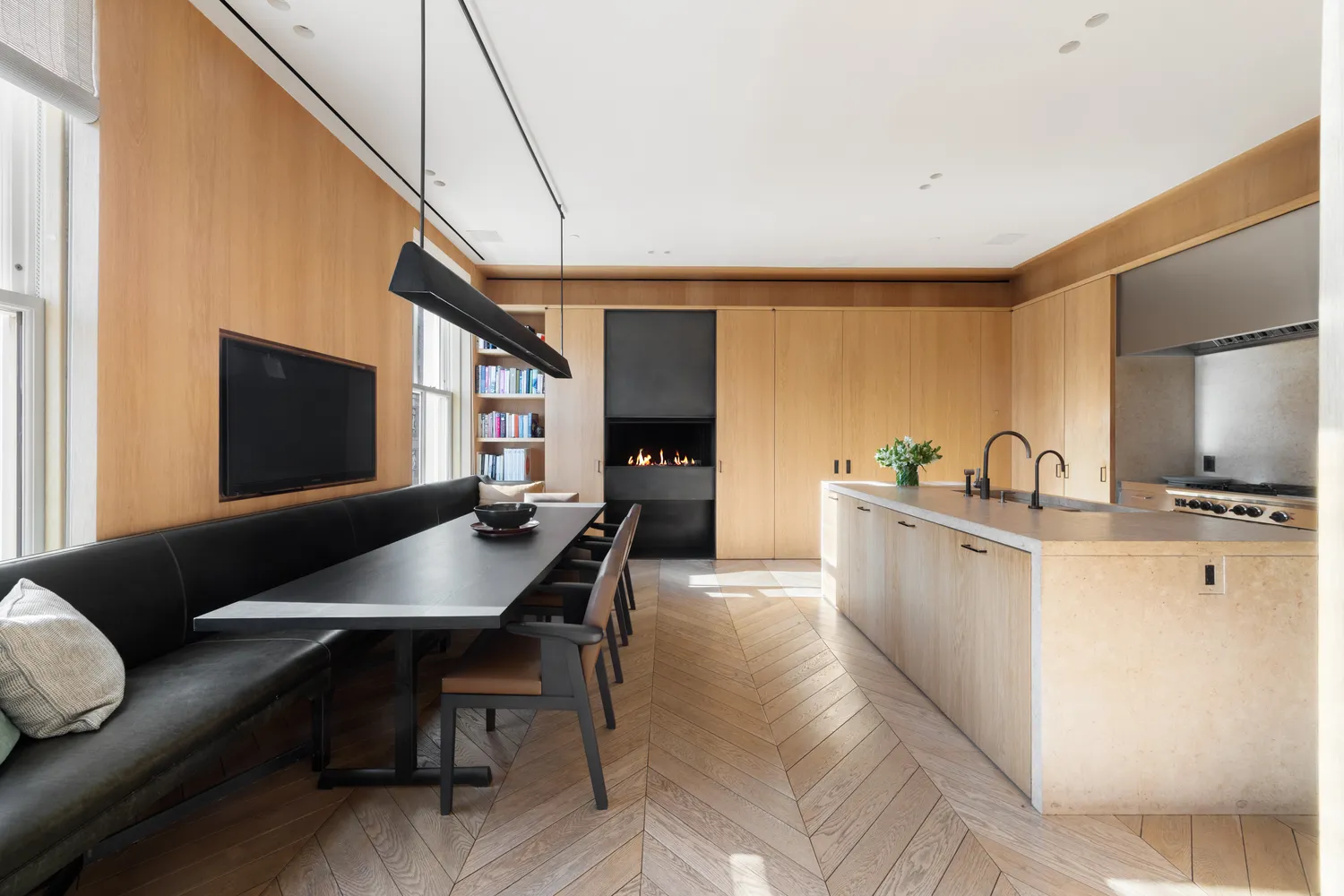 a living room with furniture a flat screen tv and kitchen view