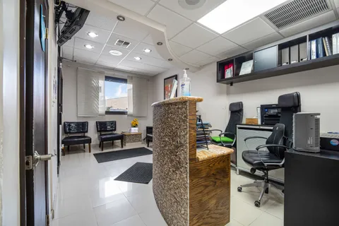 a bathroom with a glass door shower and a sink