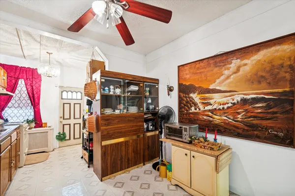 a living room with furniture a flat screen tv and a floor to ceiling window