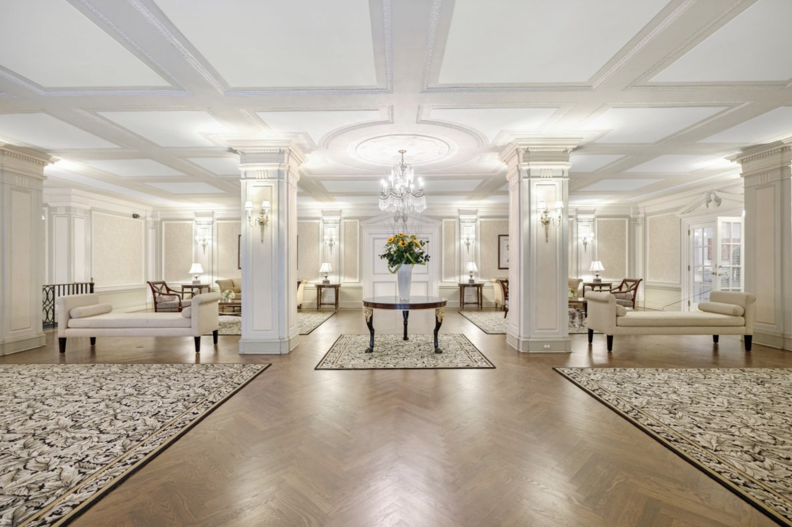 225 Central Park West, Unit 416 Manhattan, NY 10024 - Photo 12 of 16 a dining room with wooden floor a chandelier a glass table and chairs