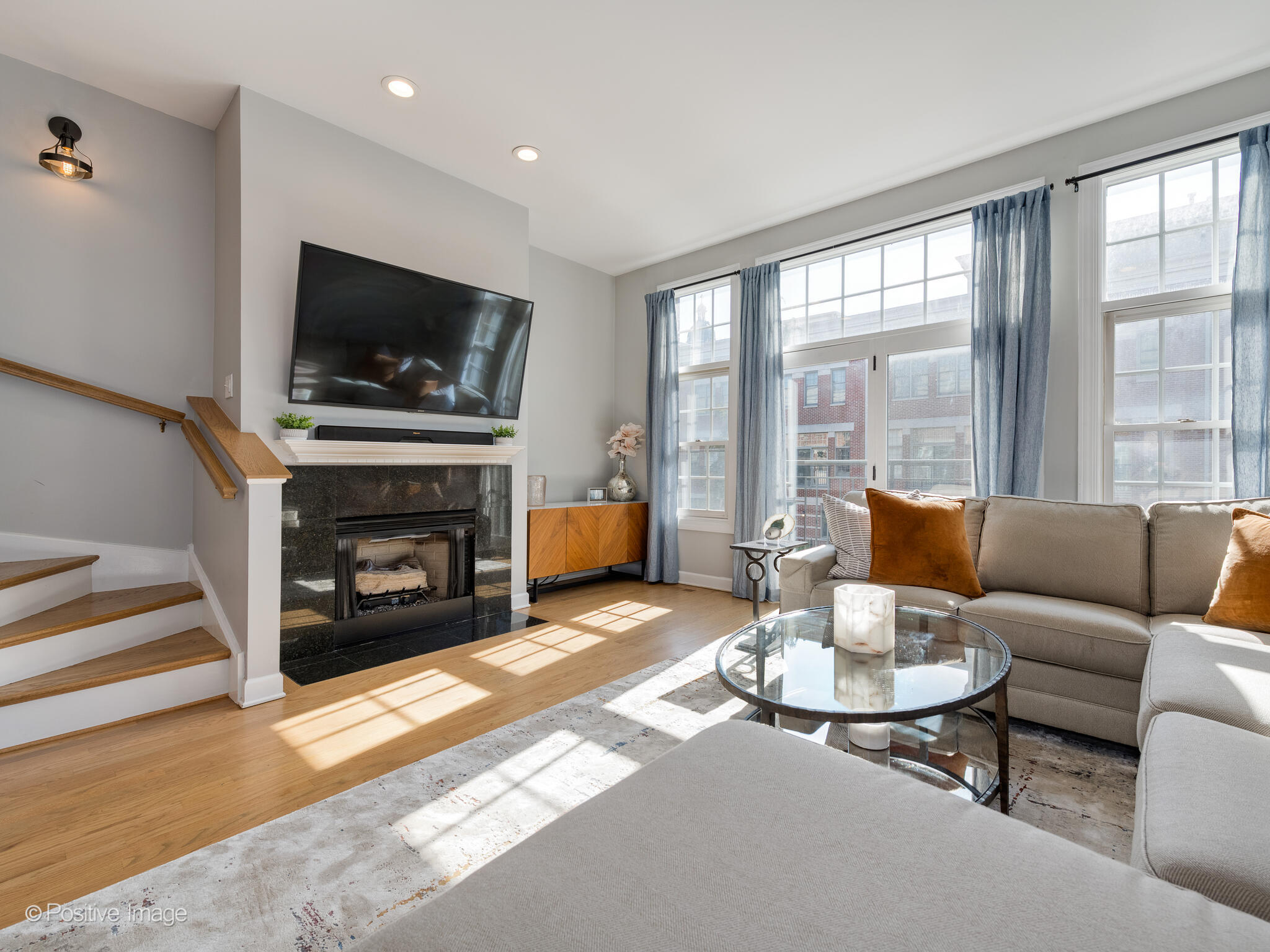 855 North May Street, Unit G Chicago, IL 60642 - Photo 8 of 28 a living room with furniture a flat screen tv and a fireplace
