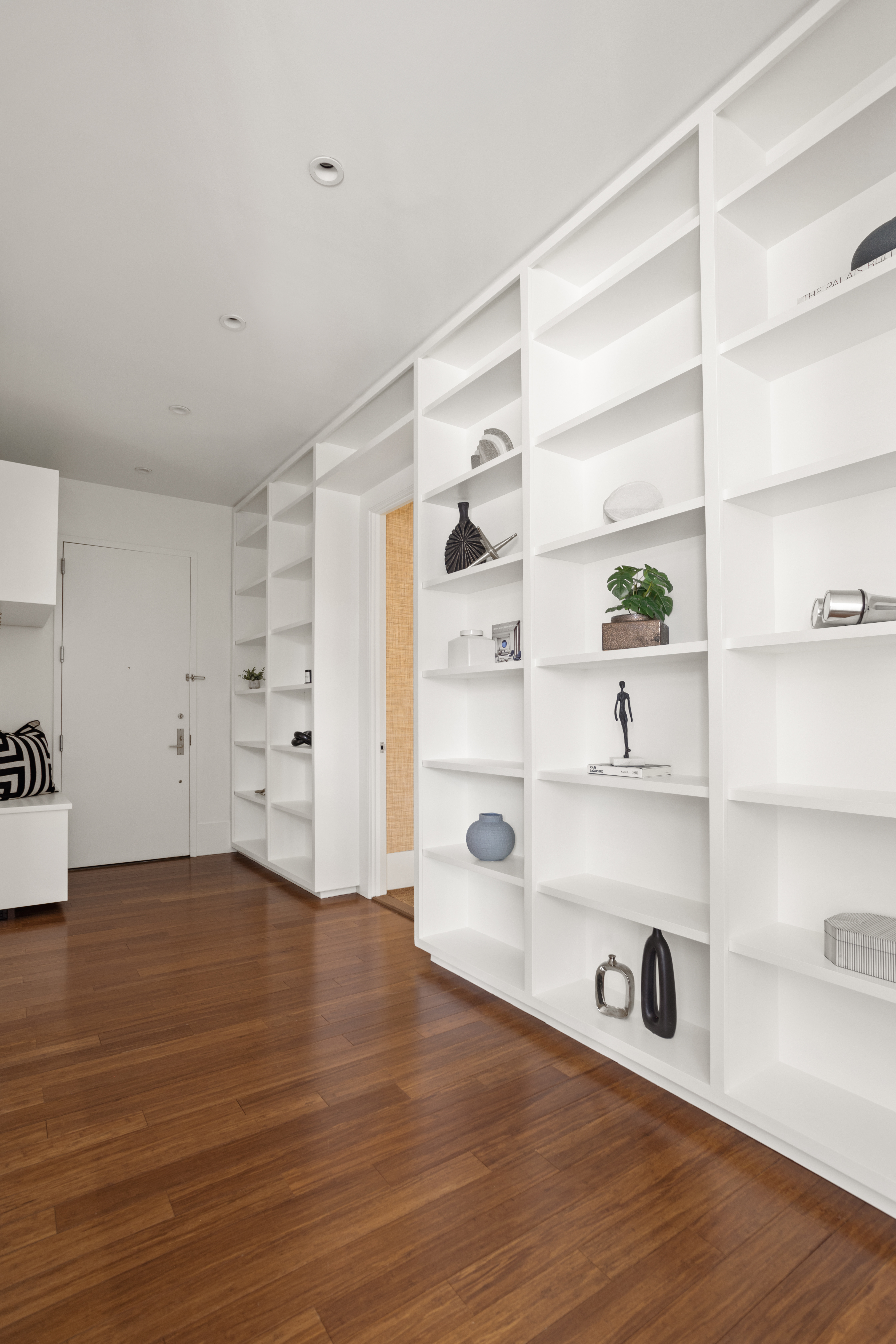 255 East 74th Street, Unit 21B Manhattan, NY 10021 - Photo 14 of 40 a view of an empty room with shelf and wooden floor