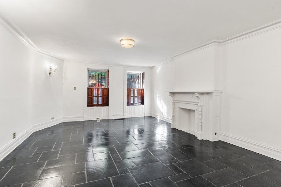 143 West 78th Street Manhattan, NY 10024 - Photo 9 of 17 an empty room with windows and fireplace