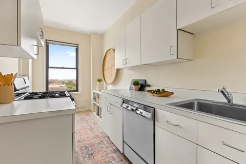 a kitchen with stainless steel appliances granite countertop a sink stove and cabinets