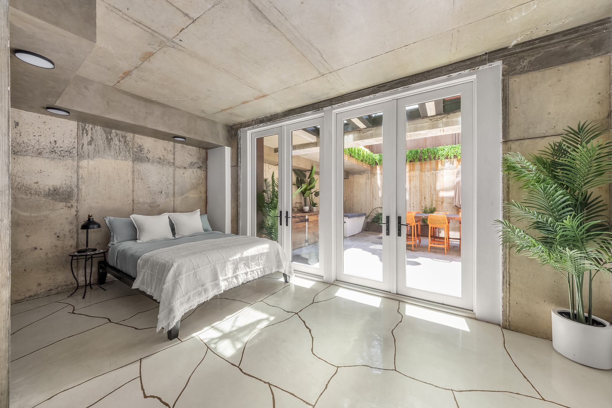 126 South 2nd Street, Unit GARDEN Brooklyn, NY 11249 - Photo 21 of 30 a spacious bedroom with a large bed and a potted plant