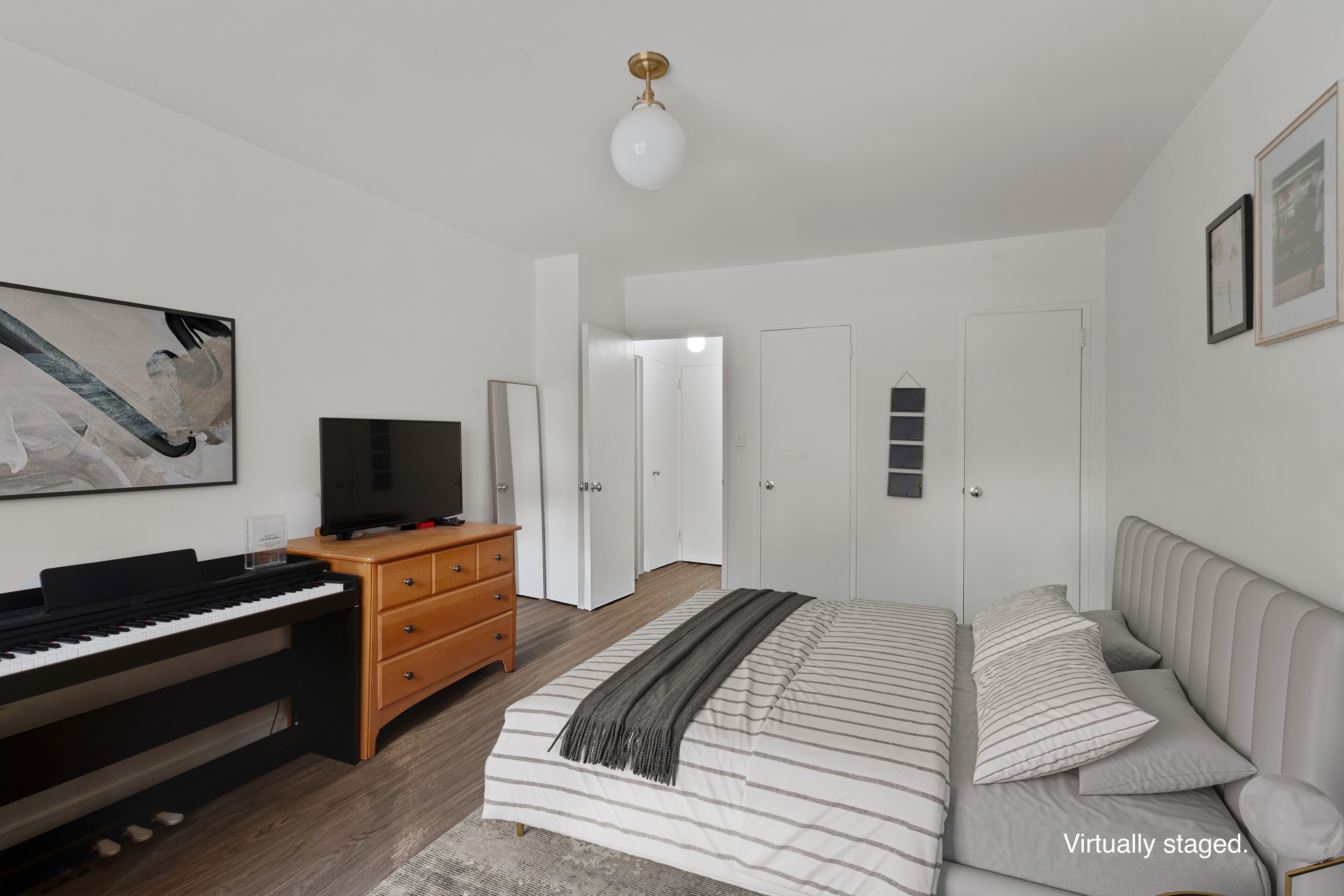 357 East 57th Street, Unit 2E Manhattan, NY 10022 - Photo 8 of 15 a bedroom with a bed and a flat screen tv