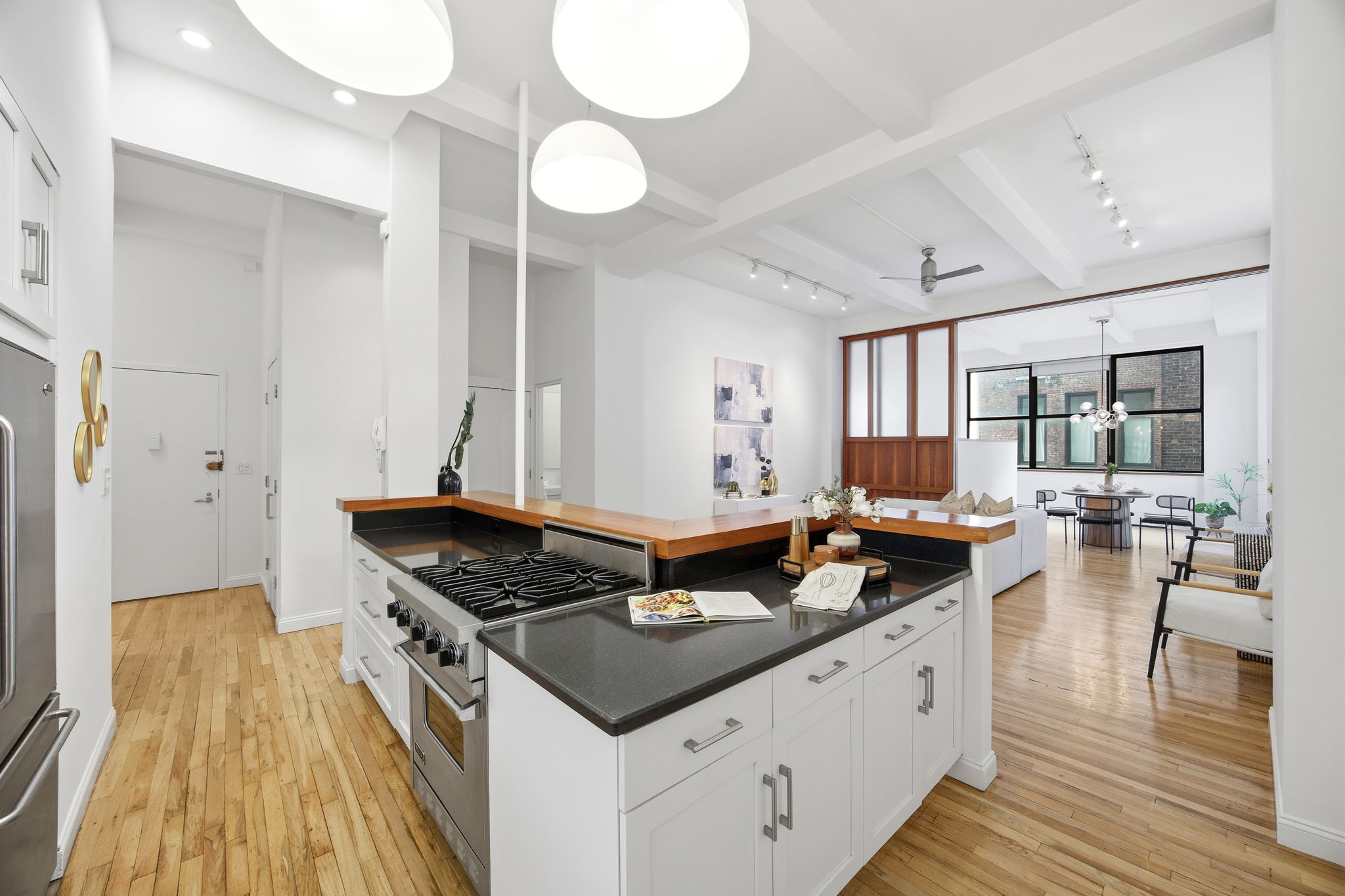 114 East 13th Street, Unit 6B Manhattan, NY 10003 - Photo 8 of 12 a kitchen with a stove and a wooden floor