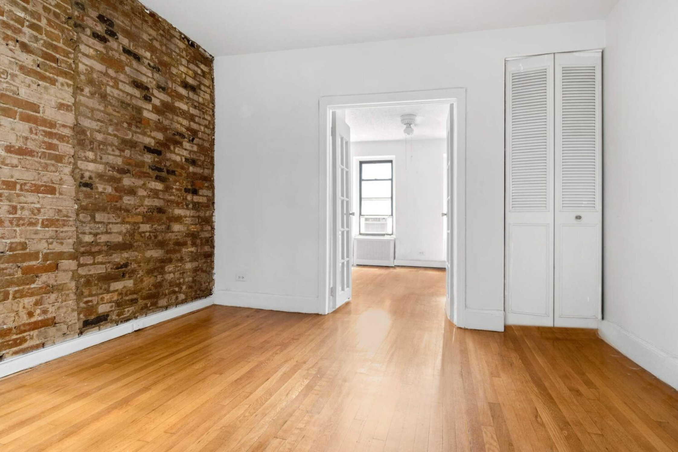 215 East 88th Street, Unit 4A Manhattan, NY 10128 - Photo 4 of 11 wooden floor in a hall with an empty room