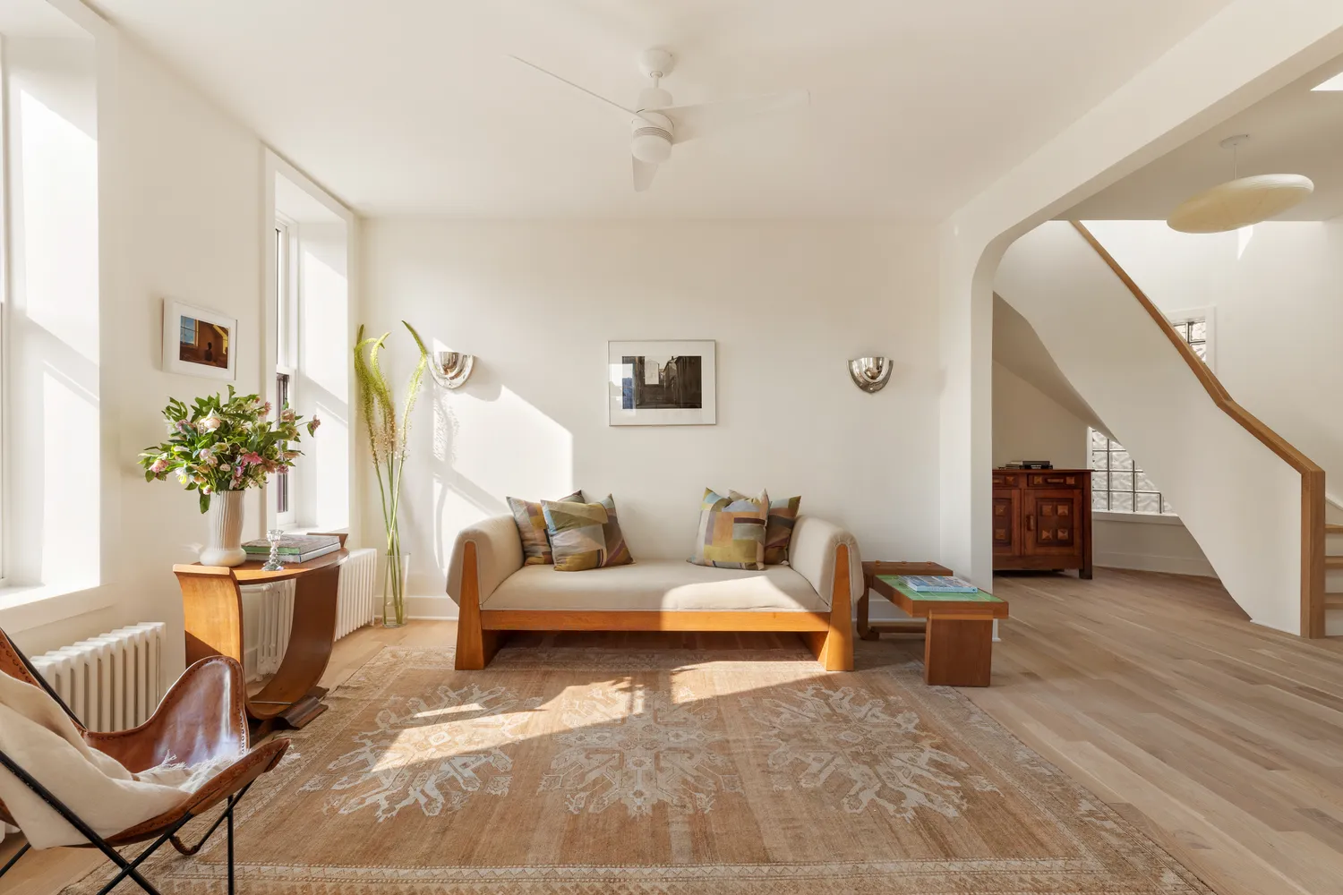 a living room with furniture and wooden floor