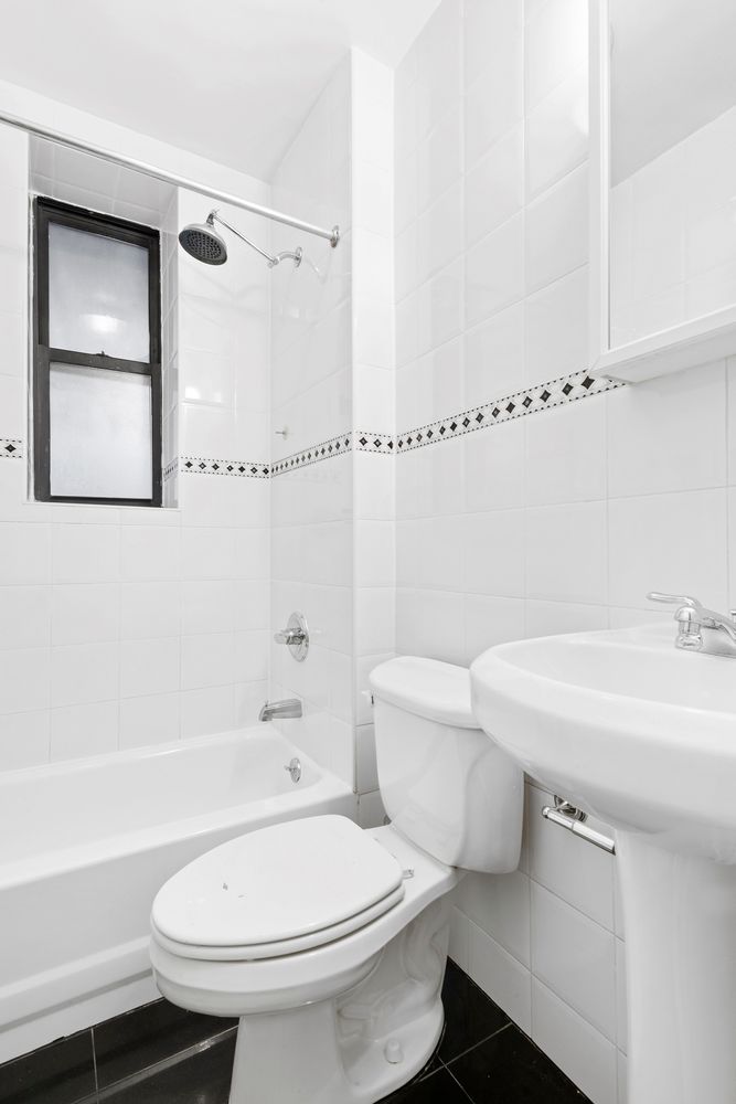 63 West 107th Street, Unit 33 Manhattan, NY 10025 - Photo 4 of 5 a white toilet sitting next to a bathroom sink
