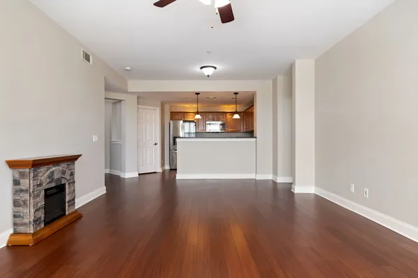 a view of a livingroom with wooden floor and a fireplace