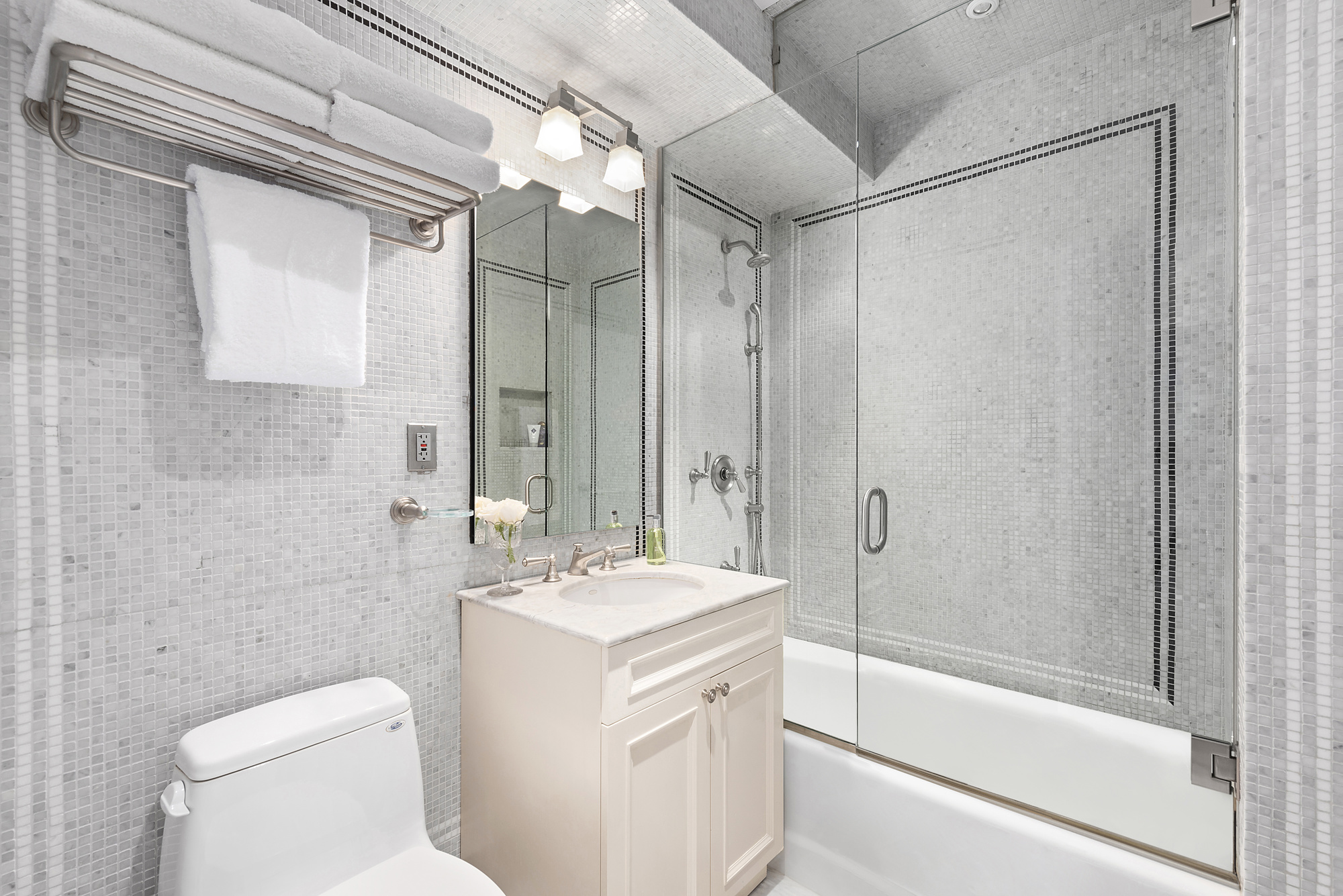 165 East 72nd Street, Unit 3L Manhattan, NY 10021 - Photo 5 of 13 a bathroom with a double vanity sink toilet and shower