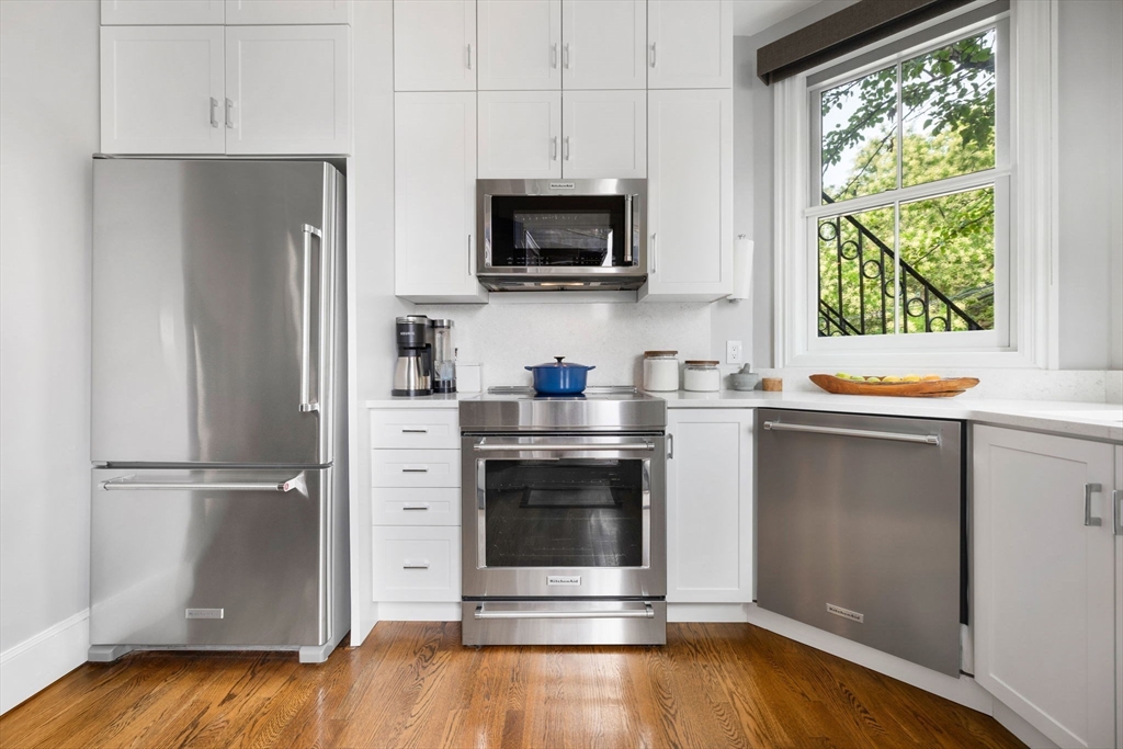 135 West Concord Street, Unit 1 Boston, MA 02118 - Photo 15 of 36 a kitchen with a refrigerator stove and wooden floor