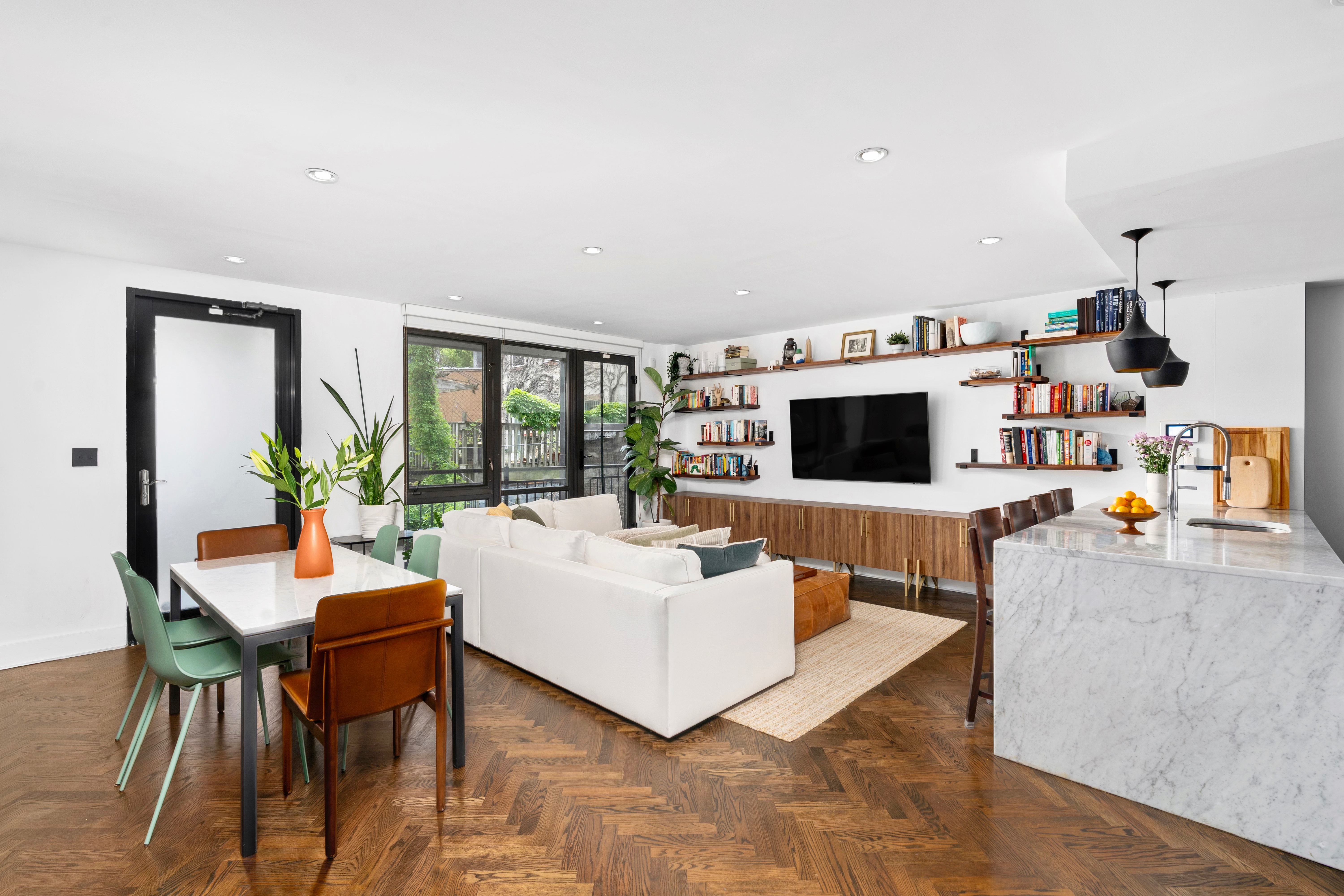 245 Manhattan Avenue, Unit 2A Brooklyn, NY 11211 - Photo 3 of 10 a living room with furniture and a flat screen tv