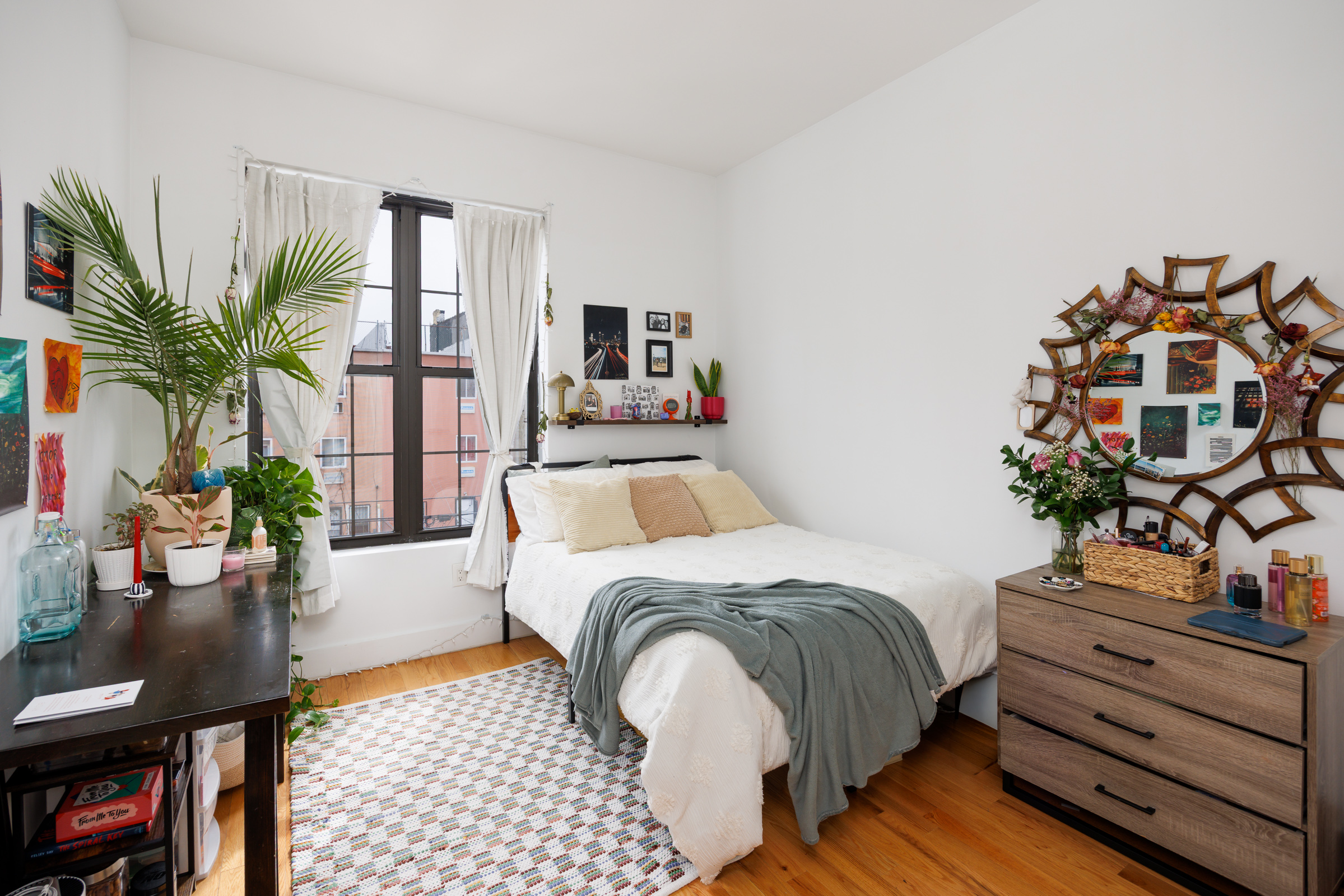 14 Pilling Street Brooklyn, NY 11207 - Photo 6 of 14 a bedroom with a bed table and a potted plant