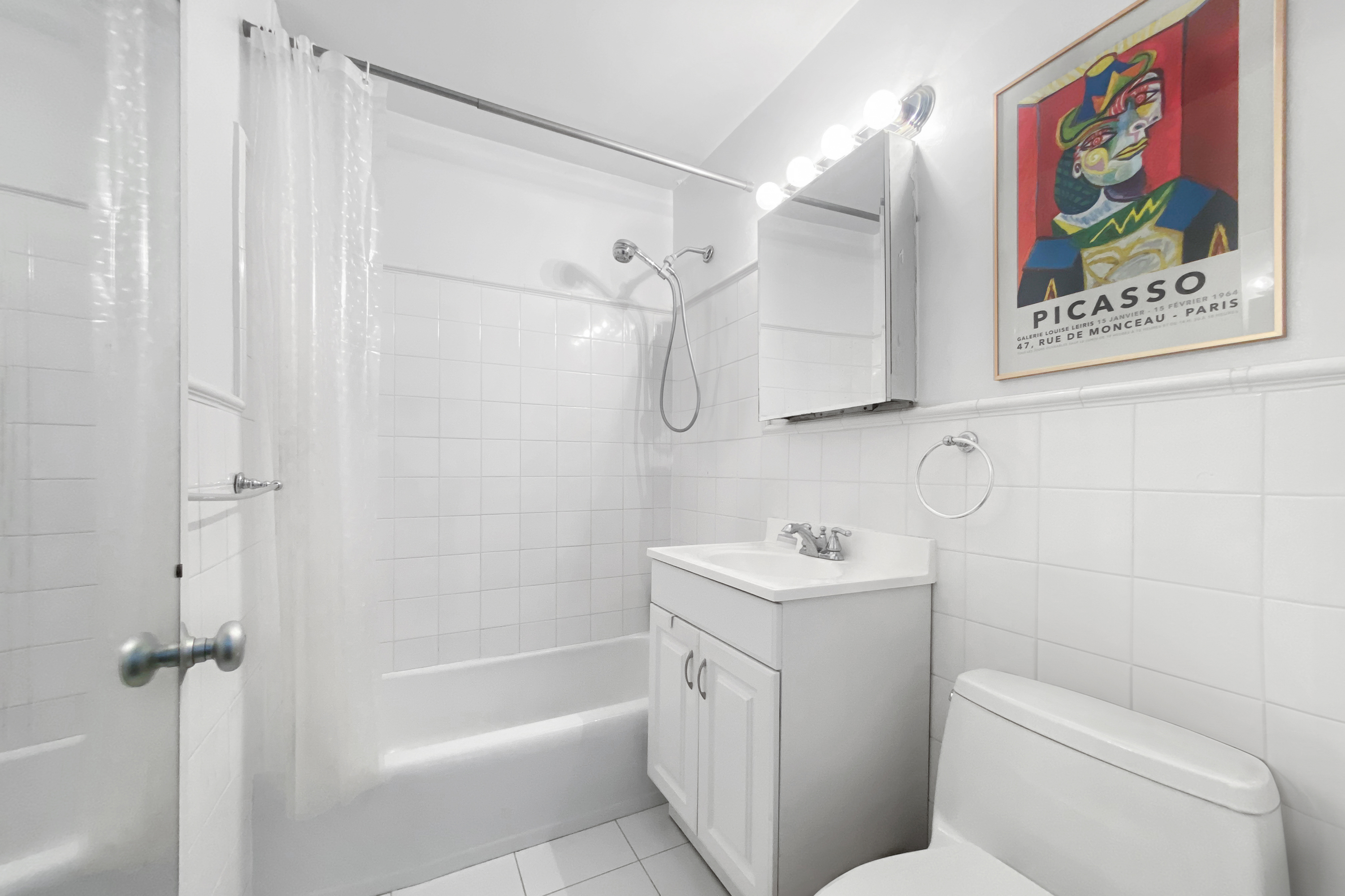 333 East 30th Street, Unit 20E Manhattan, NY 10016 - Photo 5 of 14 a bathroom with a sink mirror vanity and toilet