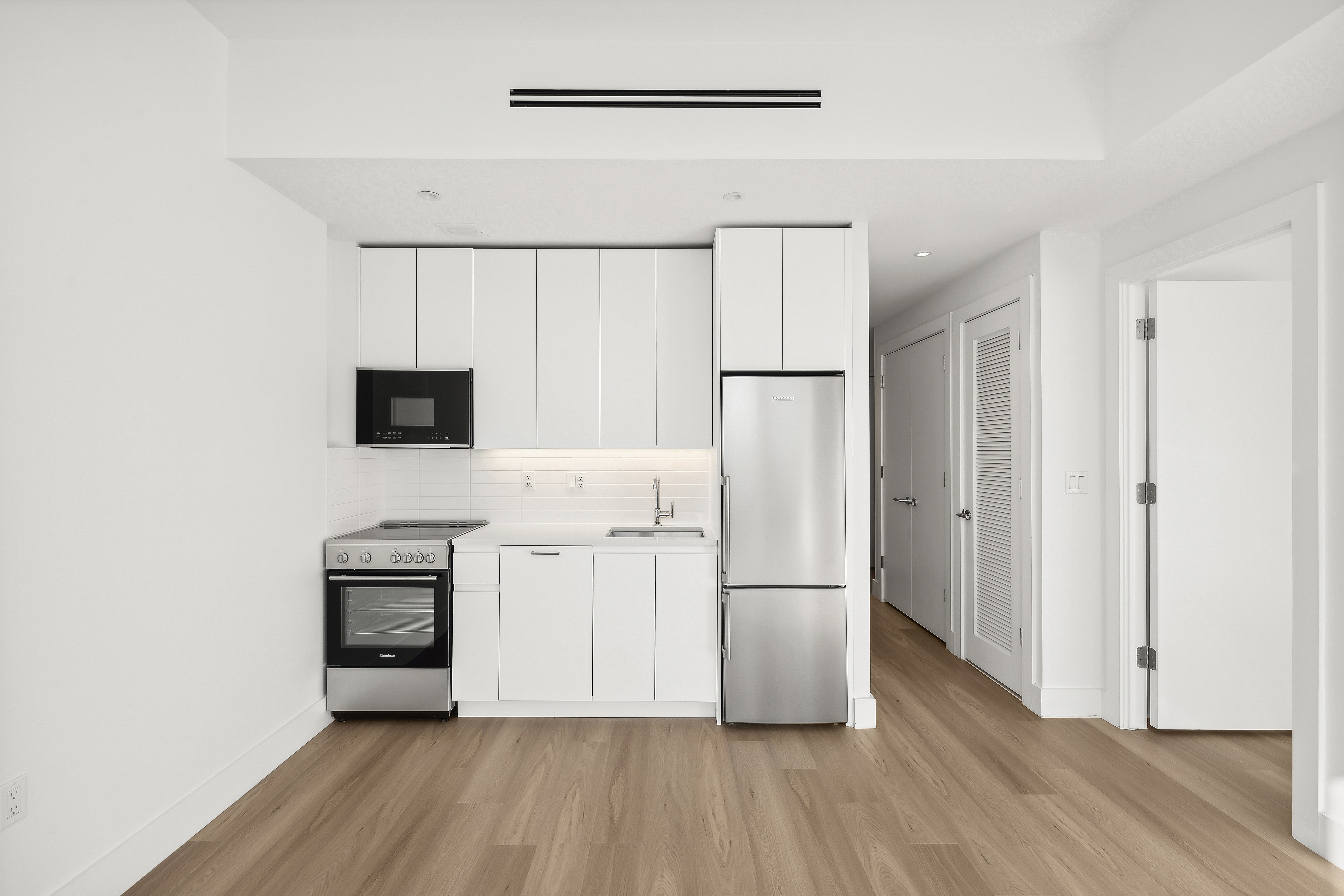 340 Lenox Road, Unit 6A Brooklyn, NY 11226 - Photo 2 of 26 a view of kitchen with wooden floor electronic appliances and cabinets