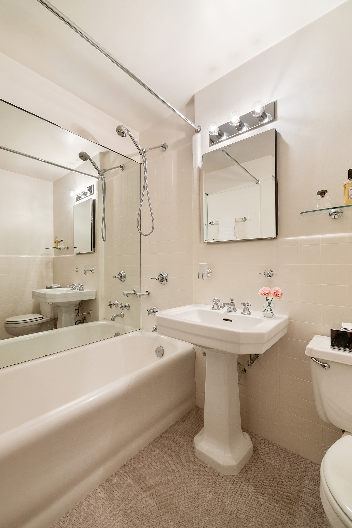 116 East 68th Street, Unit 2D Manhattan, NY 10065 - Photo 9 of 12 a bathroom with a sink a toilet and shower