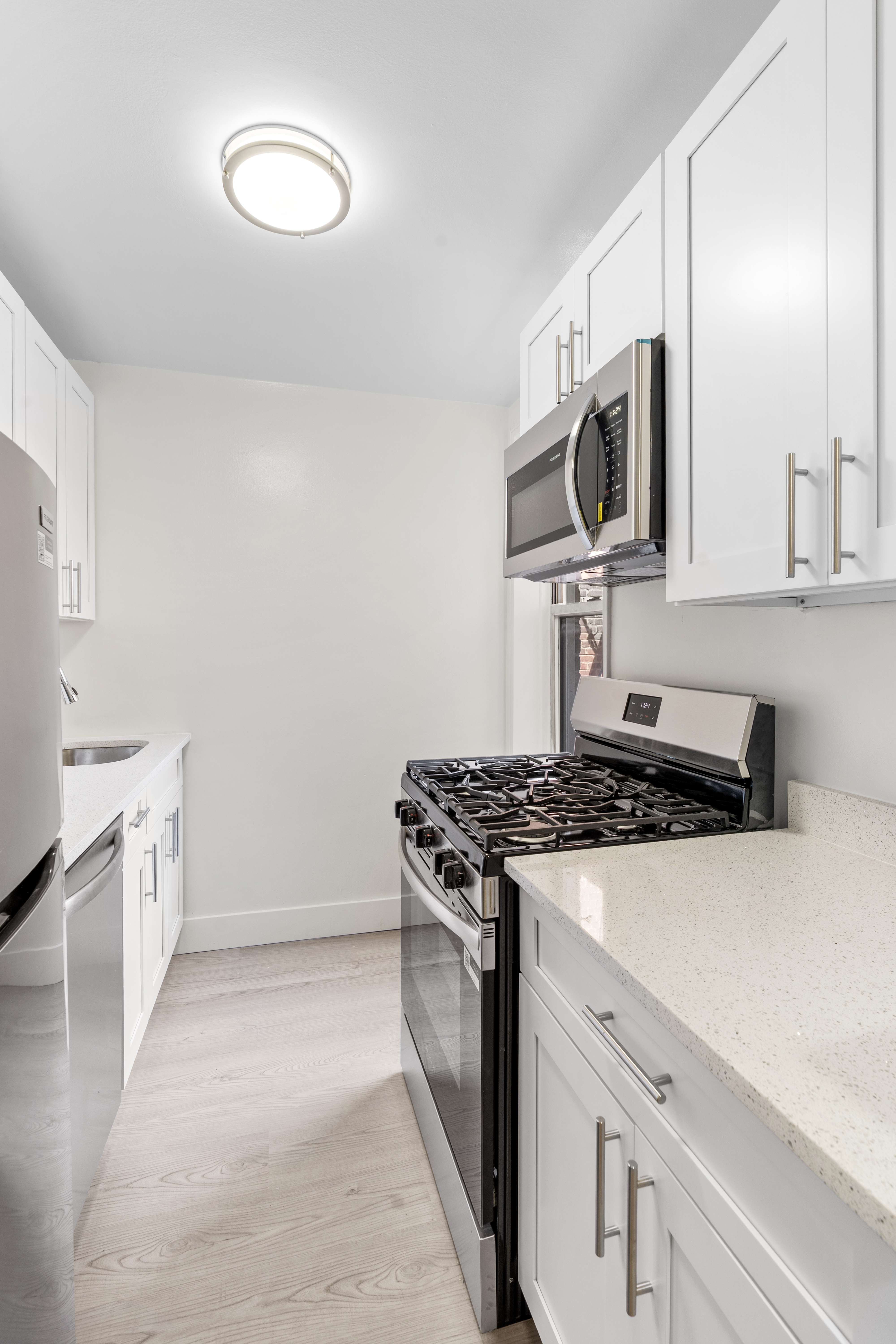 3165 Nostrand Avenue, Unit 1H Brooklyn, NY 11229 - Photo 5 of 9 a kitchen with a stove and a microwave