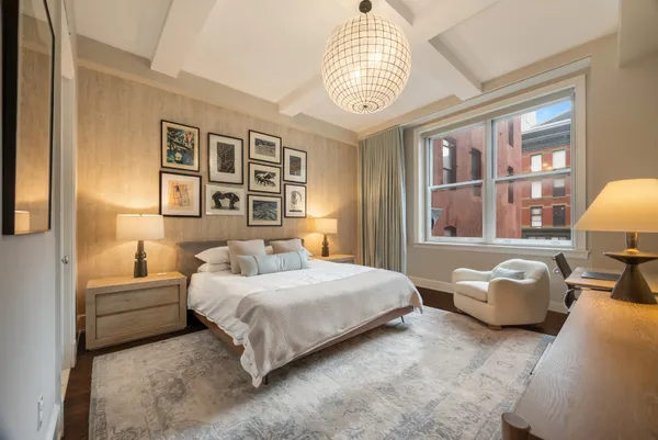 a bedroom with a bed couch and window