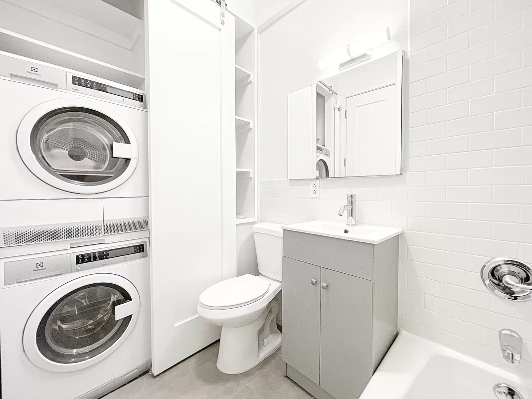 1736 2nd Avenue, Unit 4A Manhattan, NY 10128 - Photo 5 of 6 a utility room with sink washer and dryer