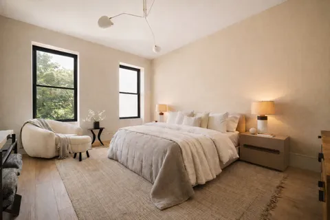 a bedroom with bed and window