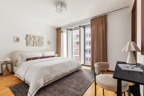 a bedroom with a bed and a table with chair