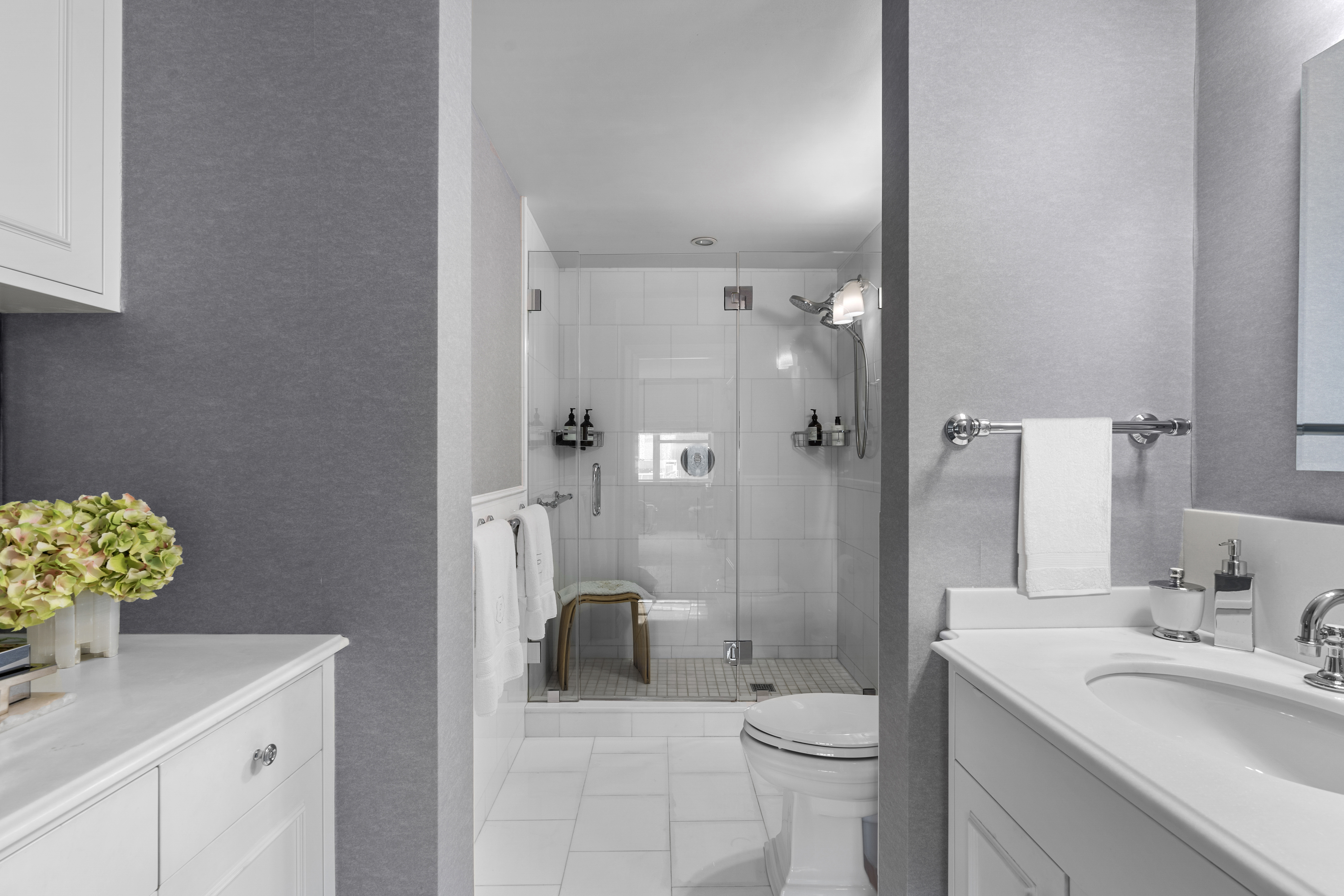 110 East 57th Street, Unit 10CD Manhattan, NY 10022 - Photo 10 of 16 a bathroom with a sink a toilet and shower