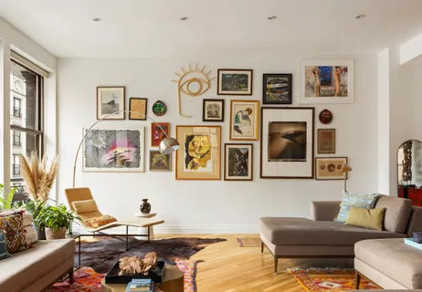 a living room with furniture and painting on the wall