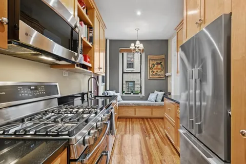 a kitchen with stainless steel appliances a sink stove and refrigerator