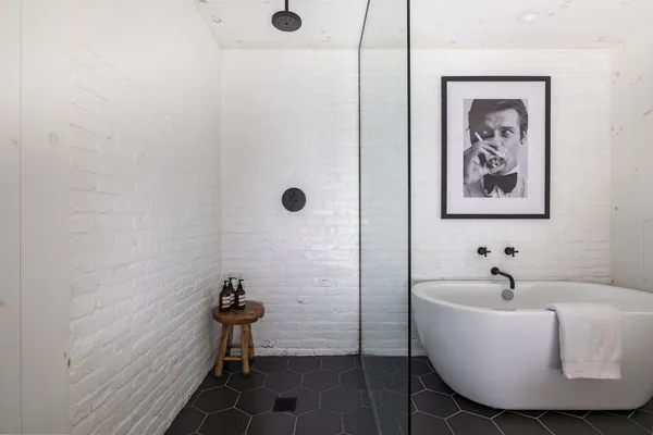 a bathroom with a bathtub and shower