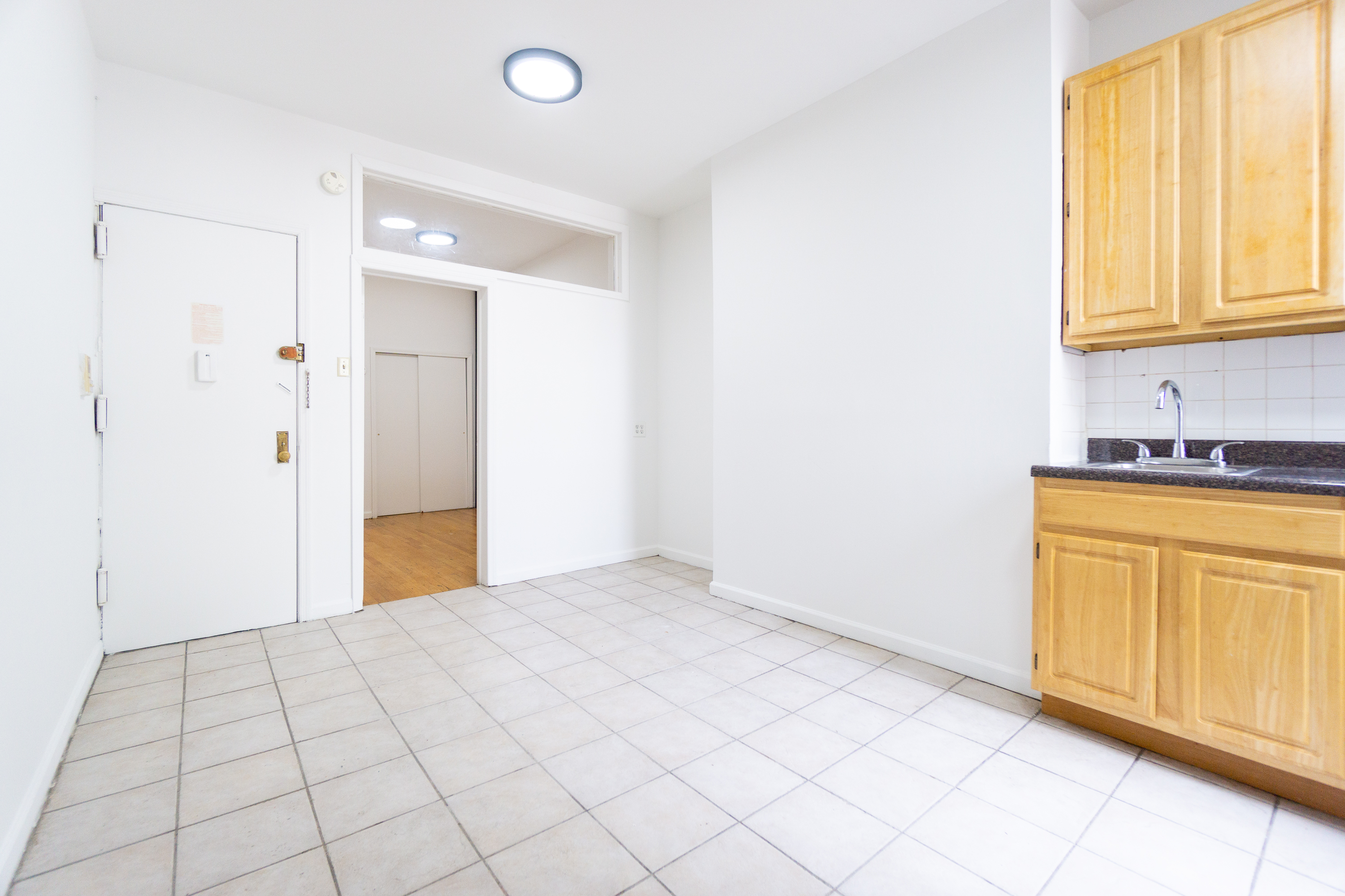 215 East 5th Street, Unit 3 Manhattan, NY 10003 - Photo 14 of 25 a view of a kitchen with wooden floor and windows