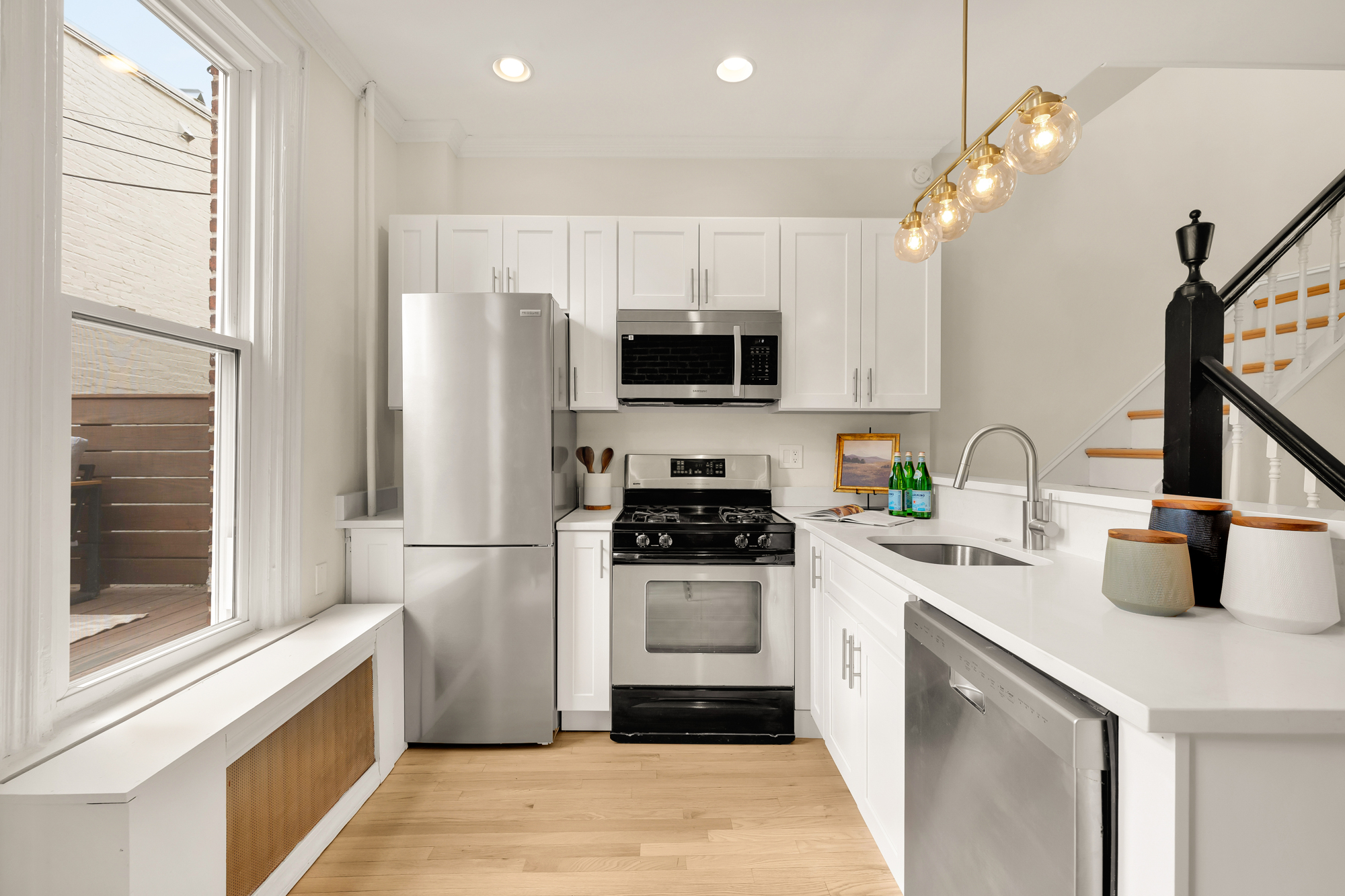 903 F Street Northeast Washington, DC 20002 - Photo 11 of 41 a kitchen with a sink a stove and refrigerator