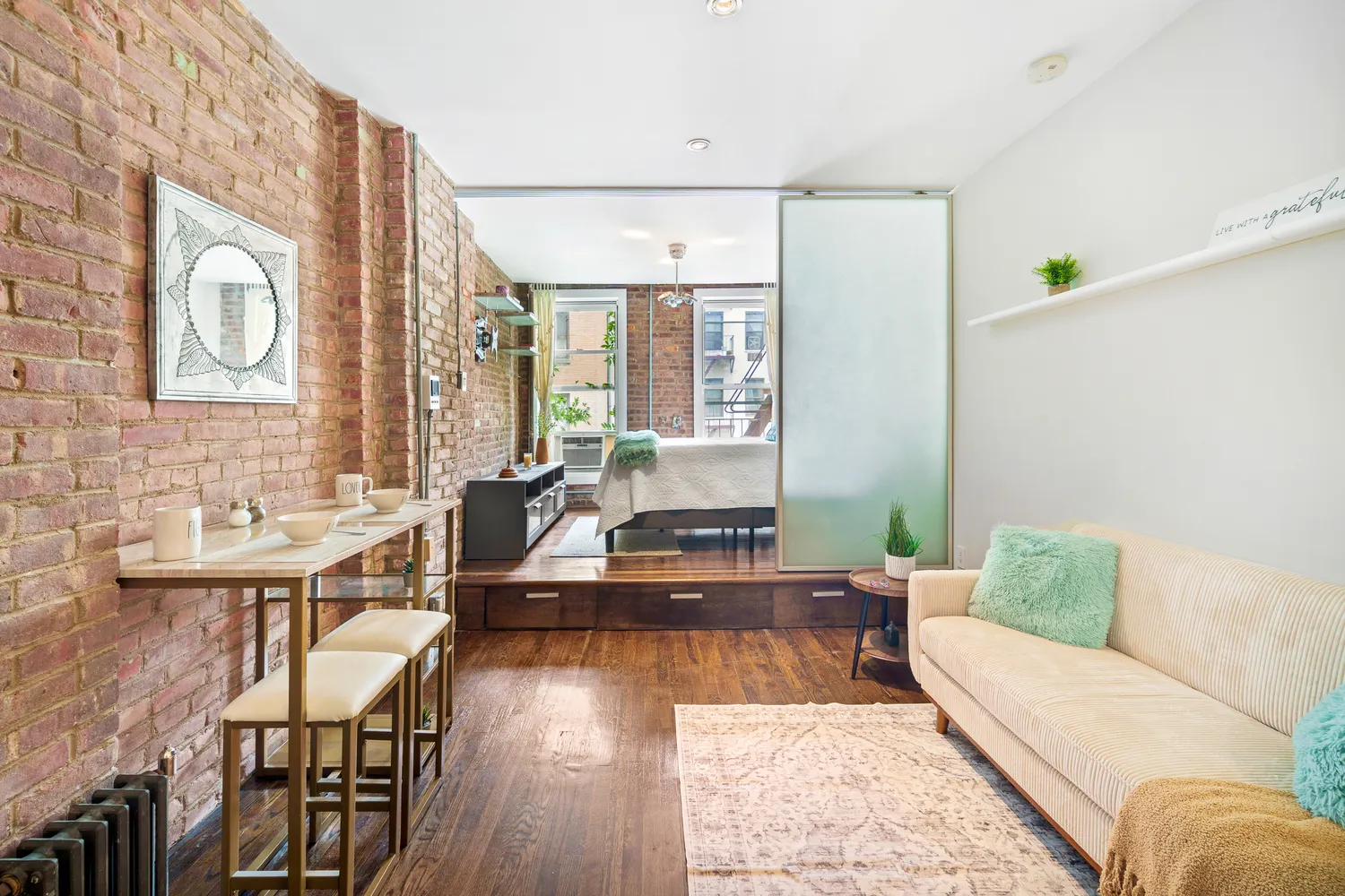 a living room with furniture and wooden floor