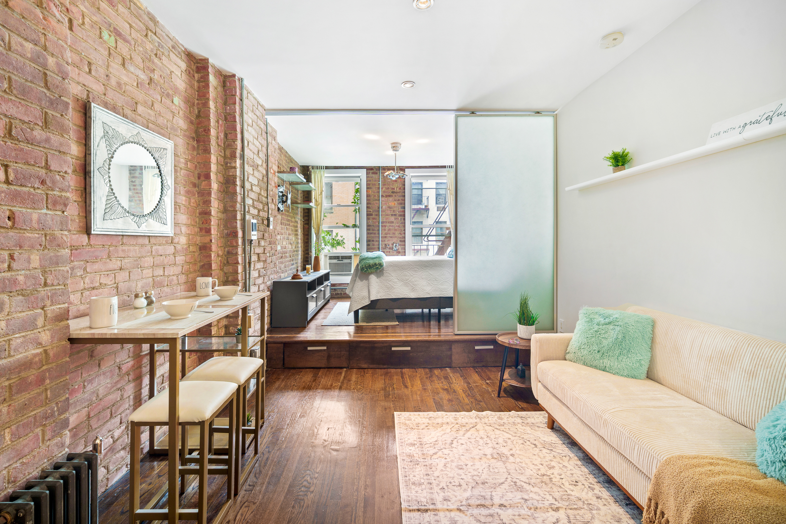 a living room with furniture and wooden floor