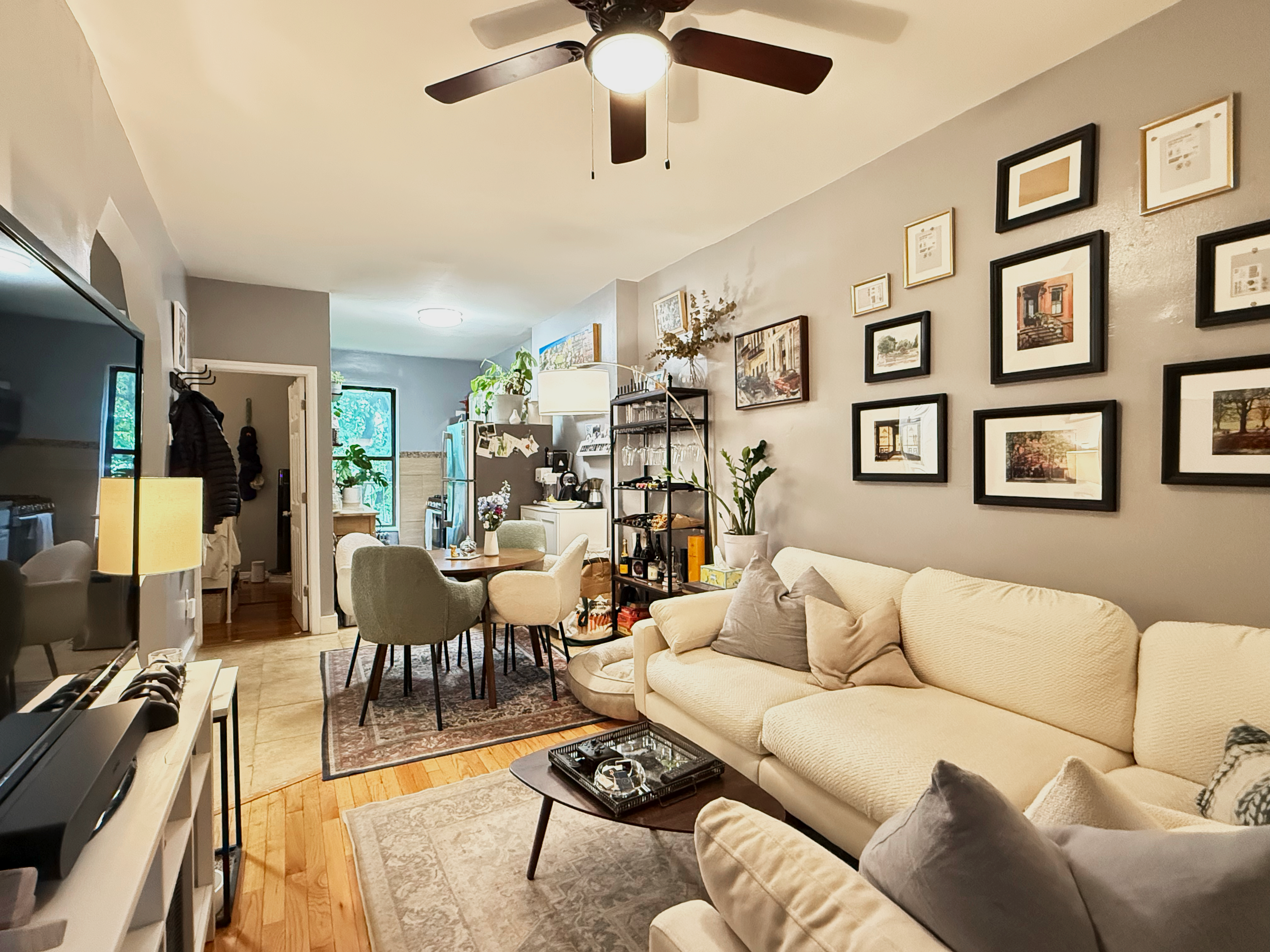630 President Street, Unit 3 Brooklyn, NY 11215 - Photo 3 of 10 a living room with furniture kitchen view and a chandelier