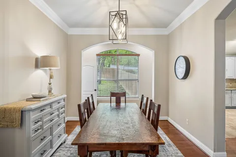 a dining room with furniture a chandelier and window