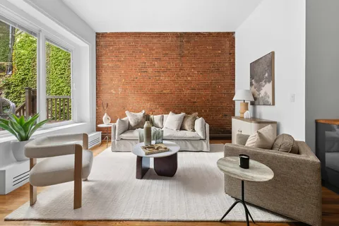 a living room with furniture and a potted plant